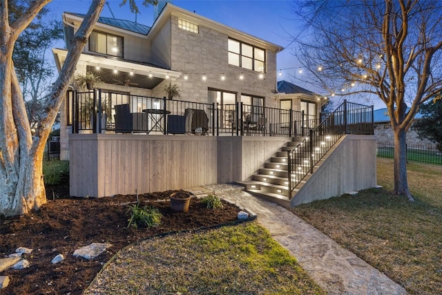 back of house featuring a standing seam roof, stairway, metal roof, and a wooden deck