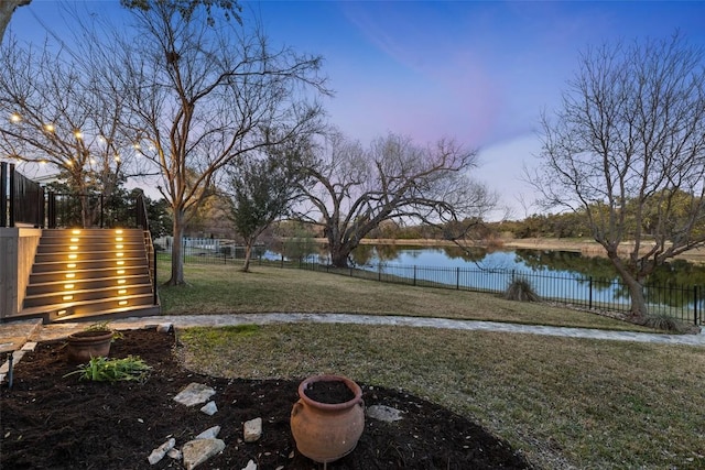 view of yard featuring a fenced backyard and a water view