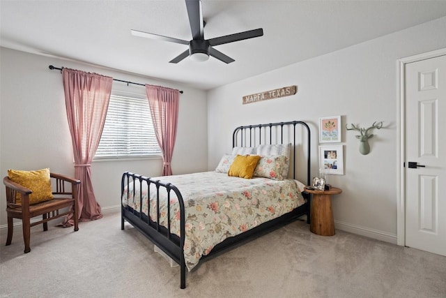 bedroom with baseboards, a ceiling fan, and light colored carpet