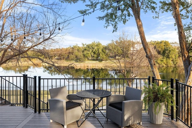 wooden terrace featuring a water view