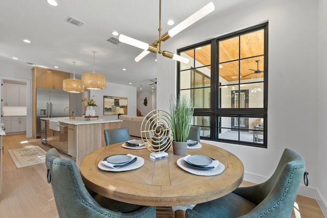 dining space with light wood-type flooring