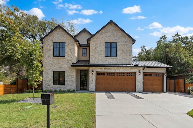 view of front of property featuring a garage and a front lawn