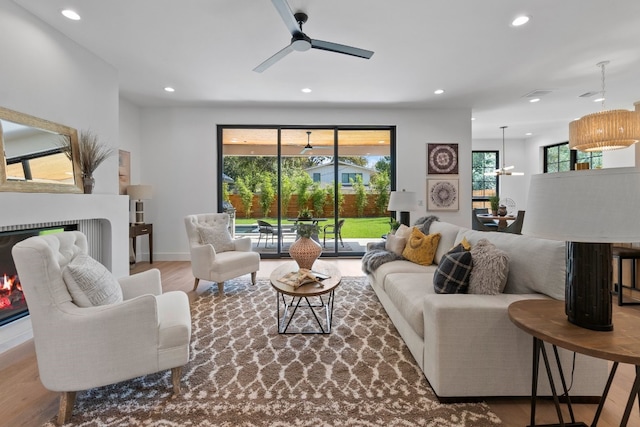 living room featuring hardwood / wood-style flooring and ceiling fan