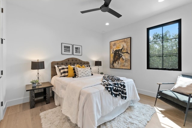 bedroom with ceiling fan and light wood-type flooring