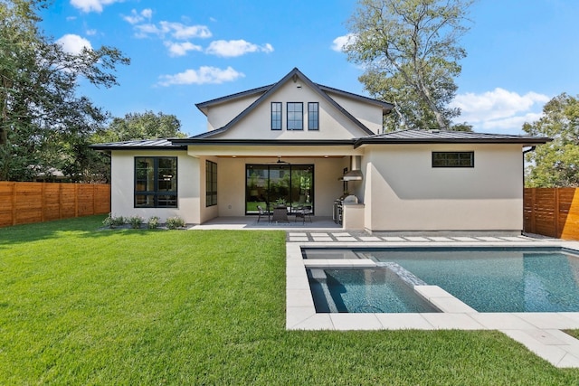 rear view of property featuring ceiling fan, a fenced in pool, a patio area, and a lawn