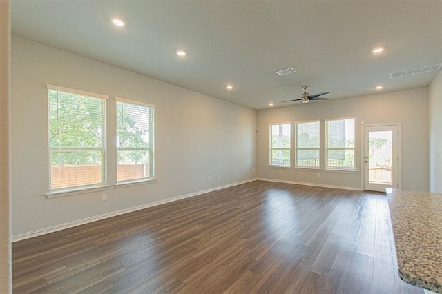 unfurnished room with dark wood-type flooring and ceiling fan