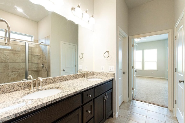 bathroom featuring vanity, a shower with shower door, and tile patterned flooring