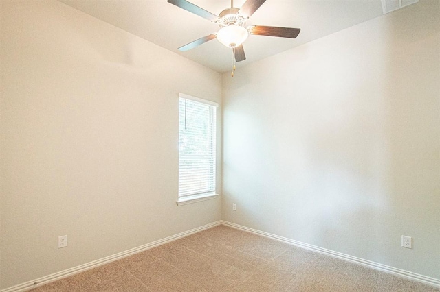 carpeted spare room with ceiling fan