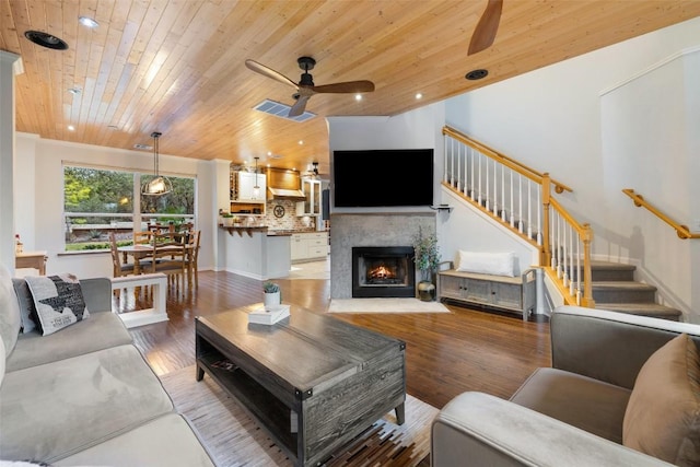 living room with wood ceiling, ceiling fan, wood-type flooring, and lofted ceiling