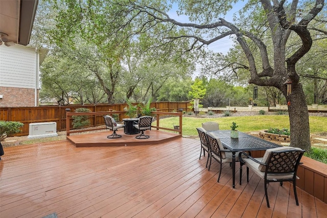 wooden terrace featuring a yard