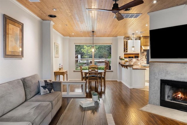 living room featuring ornamental molding and wooden ceiling