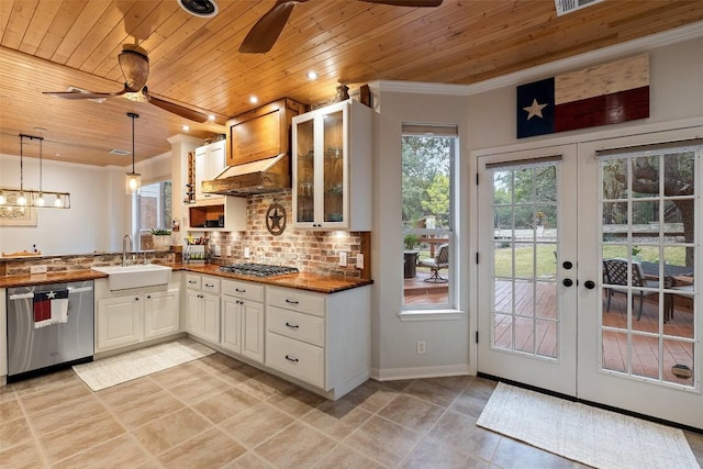 kitchen featuring sink, wood ceiling, white cabinetry, hanging light fixtures, and stainless steel appliances