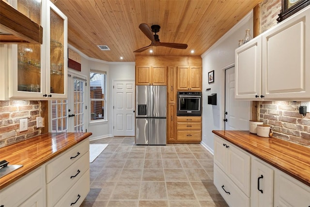 kitchen with wooden counters, stainless steel fridge, oven, and wooden ceiling