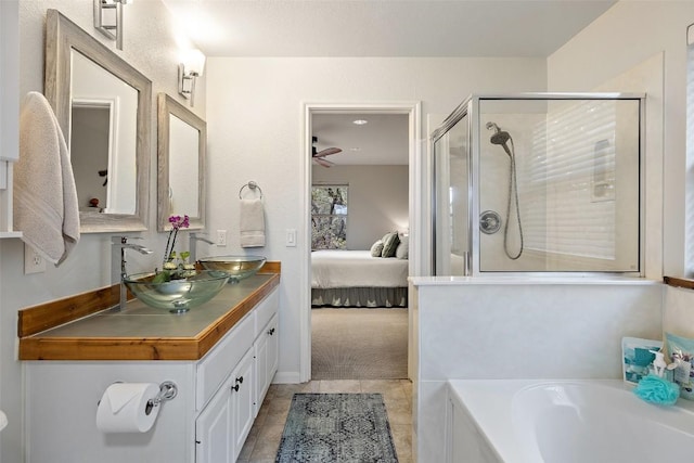 bathroom featuring vanity, tile patterned flooring, and shower with separate bathtub