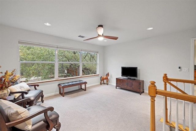 living room with ceiling fan, light colored carpet, and a wealth of natural light