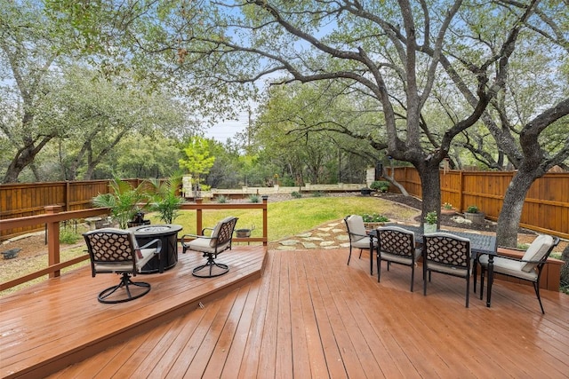 deck featuring a fire pit and a lawn