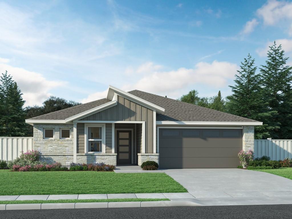 view of front of property with a garage and a front yard