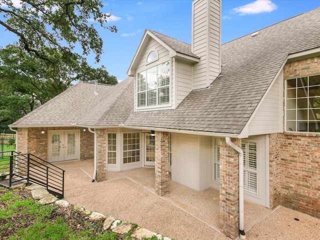 back of property with a patio and french doors