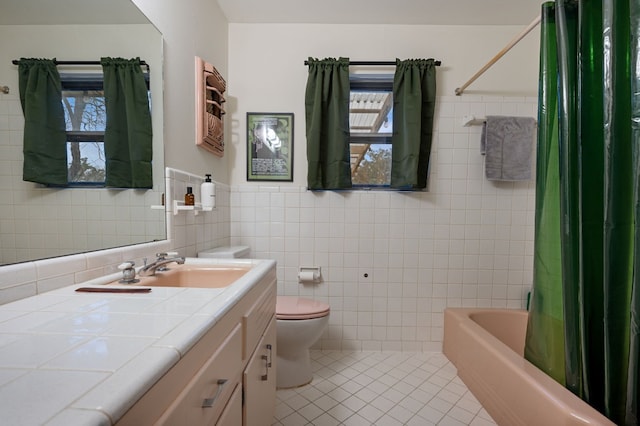 full bathroom with shower / bathtub combination with curtain, toilet, tile patterned flooring, and tile walls