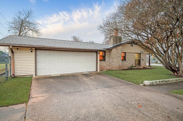 ranch-style home featuring a garage and a front lawn