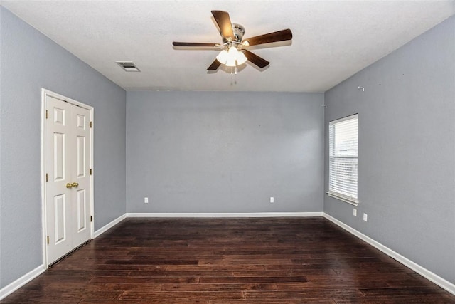 spare room with ceiling fan and dark hardwood / wood-style flooring