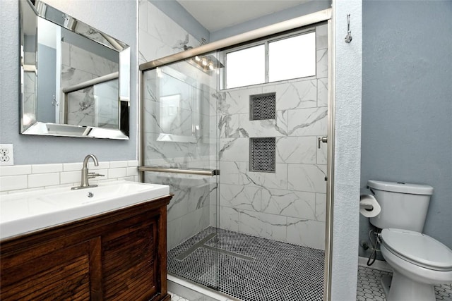 bathroom with vanity, toilet, and walk in shower