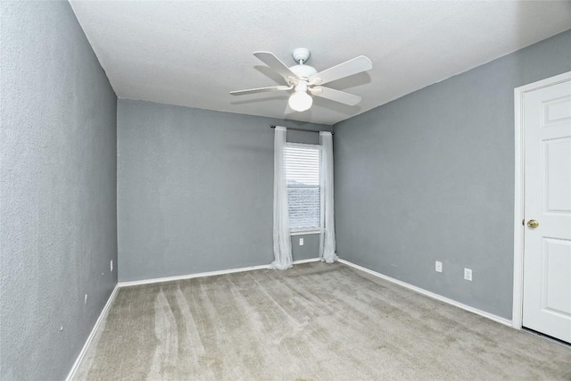 spare room with light carpet and ceiling fan