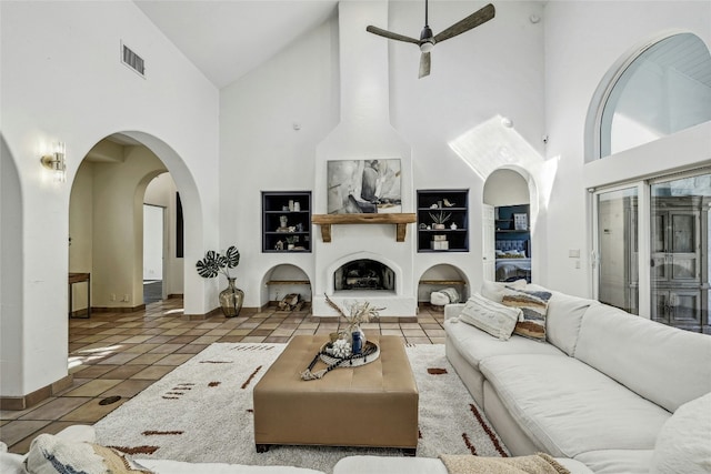 living room featuring vaulted ceiling, tile patterned floors, and ceiling fan