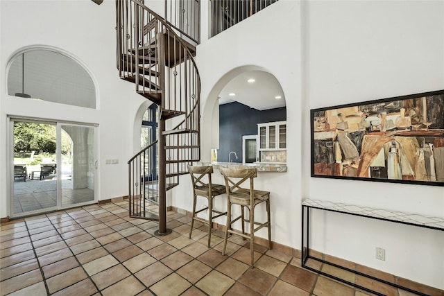 interior space with a towering ceiling and sink