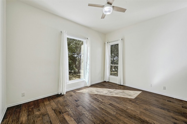 empty room featuring dark wood-type flooring and ceiling fan