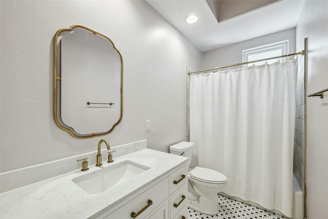 full bathroom with vanity, shower / tub combo, and toilet