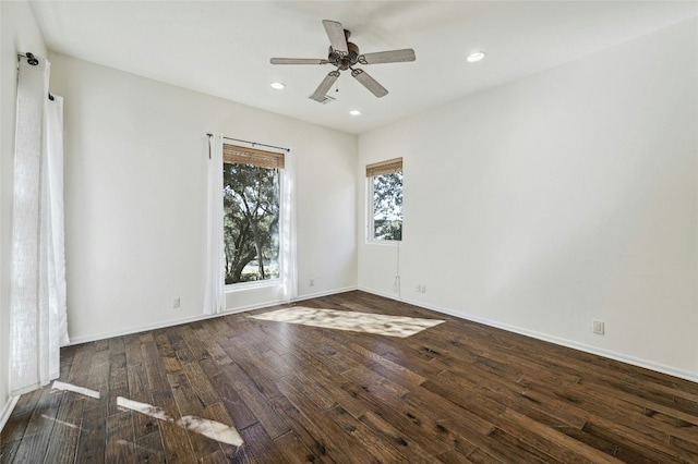 spare room with dark hardwood / wood-style flooring and ceiling fan