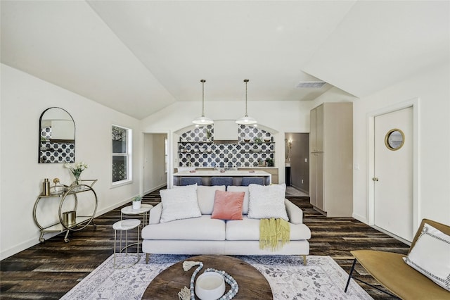 living room featuring vaulted ceiling and dark hardwood / wood-style floors