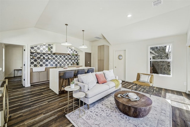 living room featuring lofted ceiling and dark hardwood / wood-style flooring