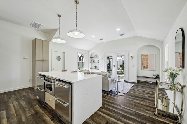 kitchen with lofted ceiling, hanging light fixtures, dark wood-type flooring, and a center island