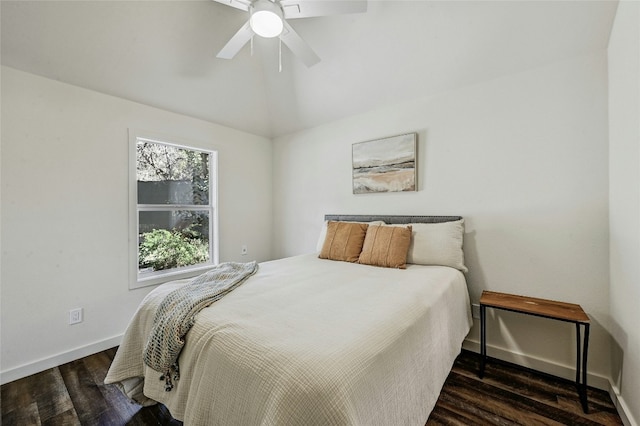 bedroom featuring vaulted ceiling, dark hardwood / wood-style floors, and ceiling fan