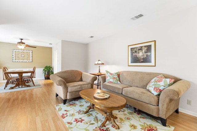 living room with light hardwood / wood-style floors and ceiling fan