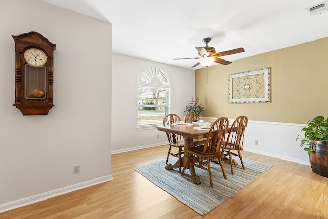 dining space with ceiling fan and light hardwood / wood-style flooring