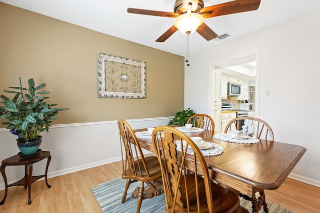 dining area featuring ceiling fan and light wood-type flooring