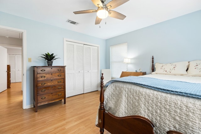 bedroom with light hardwood / wood-style flooring, a closet, and ceiling fan