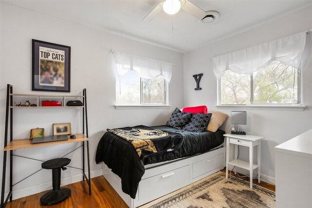 bedroom with wood-type flooring and ceiling fan