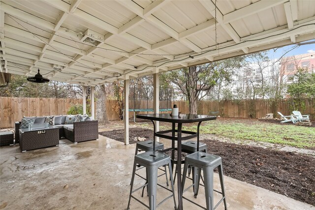 view of patio with an outdoor living space and a trampoline