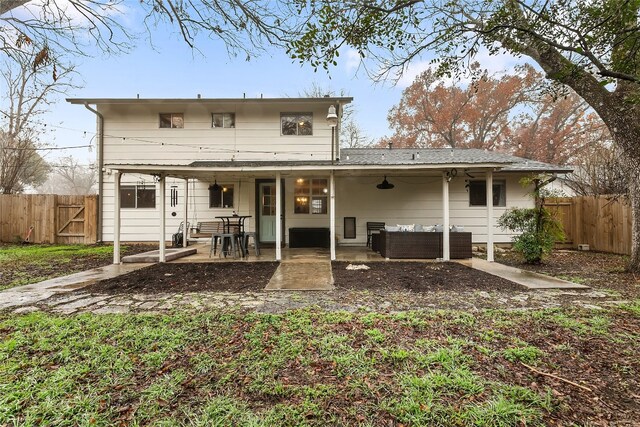 back of property featuring an outdoor living space and a patio