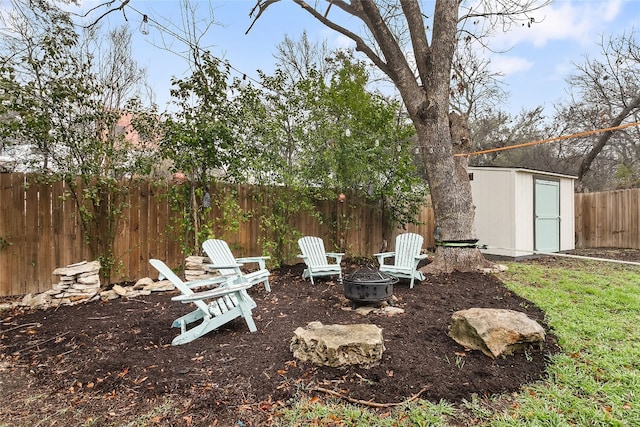 view of yard featuring a shed and a fire pit