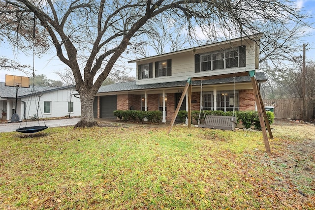 front facade featuring a porch, a garage, and a front lawn