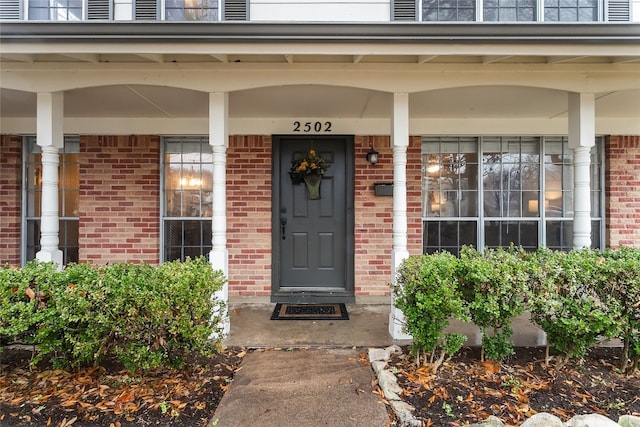 view of exterior entry with covered porch