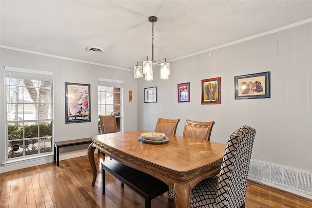 2502 Spruceleaf Cir, Austin, TX 78757 - dining room with wood-type flooring, ornamental molding, a chandelier, and baseboards