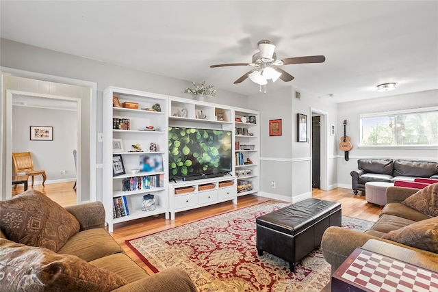 living room with ceiling fan and light hardwood / wood-style flooring