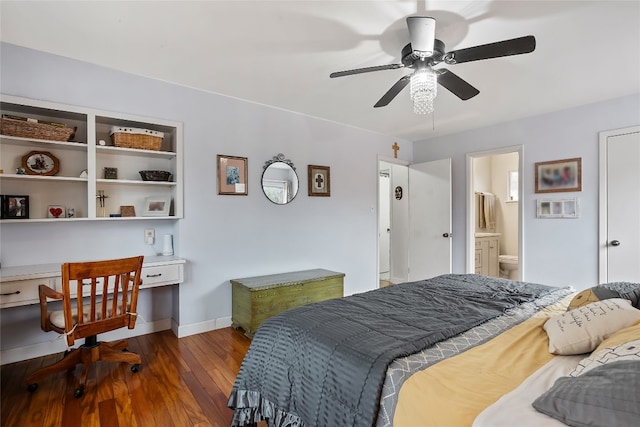 bedroom with built in desk, connected bathroom, hardwood / wood-style floors, and ceiling fan