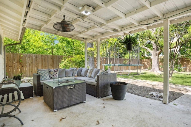 2502 Spruceleaf Cir, Austin, TX 78757 - view of patio featuring a trampoline, an outdoor living space with a fire pit, a fenced backyard, and ceiling fan